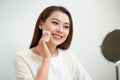 Beautiful girl cleans the face of makeup with a cotton pad Royalty Free Stock Photo