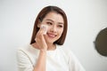 Beautiful girl cleans the face of makeup with a cotton pad Royalty Free Stock Photo