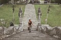 Beautiful Girl Climbing Up Stone Stairs In Pura Lempuyang Temple In Bali, Indonesia.