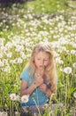 Adorable girl blowing white dandelion flowers Royalty Free Stock Photo