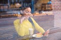 Beautiful girl with coffee viewed through the window Royalty Free Stock Photo