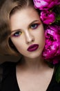 Beautiful girl with colorful make-up, flowers, retro hairstyle. beauty face. Royalty Free Stock Photo