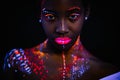 Beautiful girl with creative fluorescent prints on skin Royalty Free Stock Photo