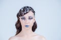 Beautiful girl with creative make-up for the new year. Winter portrait. Bright colors, blue lips, elegant design hair Royalty Free Stock Photo