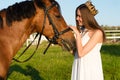 Beautiful girl with a crown caress horse Royalty Free Stock Photo