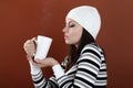 Beautiful girl with cup in hands to keep warm drink Royalty Free Stock Photo