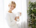 Beautiful girl with a cup in the morning Royalty Free Stock Photo