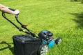 Beautiful girl cuts the lawn. Mowing lawns. Lawn mower on green grass. mower grass equipment. mowing gardener care work tool Royalty Free Stock Photo