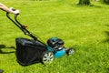 Beautiful girl cuts the lawn, Mowing lawns, Lawn mower on green grass, mower grass equipment, mowing gardener care work tool Royalty Free Stock Photo