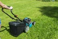 Beautiful girl cuts the lawn. Mowing lawns. Lawn mower on green grass. mower grass equipment. mowing gardener care work tool Royalty Free Stock Photo