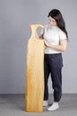 Beautiful girl. Cutting board. Young woman hold a large kitchen board in her hands. Royalty Free Stock Photo