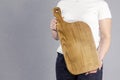 Beautiful girl. Cutting board. Young woman hold a large kitchen board in her hands. Royalty Free Stock Photo