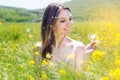 Beautiful girl with dandelion in yellow field Royalty Free Stock Photo