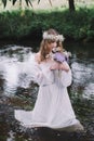 Beautiful girl in a dark forest near the river. Royalty Free Stock Photo