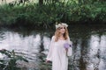 Beautiful girl in a dark forest near the river. Royalty Free Stock Photo