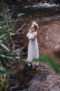 Beautiful girl in a dark forest near the river. Royalty Free Stock Photo