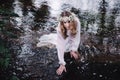 Beautiful girl in a dark forest near the river. Royalty Free Stock Photo