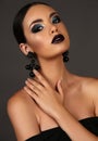 Beautiful girl with dark hair with bright extravagant makeup and bijou Royalty Free Stock Photo