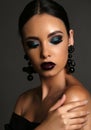 Beautiful girl with dark hair with bright extravagant makeup and bijou Royalty Free Stock Photo