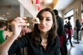 Beautiful girl with dark hair, dressed in black is holding chopsticks with sushi Royalty Free Stock Photo