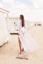 Beautiful girl with dark hair in elegant swimming suit relaxing on the summer beach Royalty Free Stock Photo