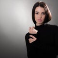 Beautiful girl with dark hair posing over gray background. Young pretty woman Royalty Free Stock Photo