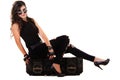 Beautiful girl in dark leather clothes holding a large retro radio