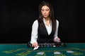 The beautiful girl, dealer, behind a table for poker Royalty Free Stock Photo