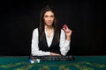 The beautiful girl, dealer, behind a table for poker Royalty Free Stock Photo