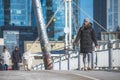 Beautiful girl with dog, without mask, walking in the city Royalty Free Stock Photo