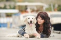 Beautiful girl with a dog on the pier in the summer Royalty Free Stock Photo