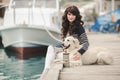 Beautiful girl with a dog on the waterfront Royalty Free Stock Photo