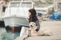 Beautiful girl with a dog on the waterfront Royalty Free Stock Photo