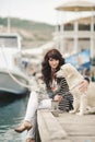 Beautiful girl with a dog on the waterfront Royalty Free Stock Photo