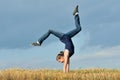 Beautiful girl doing a handstand in a meadow Royalty Free Stock Photo