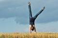 Beautiful girl doing a handstand in a meadow Royalty Free Stock Photo