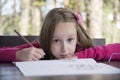 Beautiful girl doing homework at the park Royalty Free Stock Photo