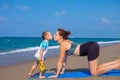 A beautiful girl is doing yoga on the beach near the sea Royalty Free Stock Photo