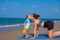 A beautiful girl is doing yoga on the beach near the sea Royalty Free Stock Photo