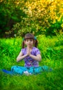 Beautiful girl doing yoga outdoors On green grass Royalty Free Stock Photo