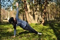 Beautiful girl doing yoga at the park at a sunny day. Royalty Free Stock Photo