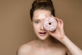 Beautiful girl with donut in hand and tinsel makeup Royalty Free Stock Photo