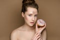 Beautiful girl with donut in hand and tinsel makeup Royalty Free Stock Photo