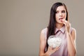 Beautiful girl doubts and licks sugar Royalty Free Stock Photo