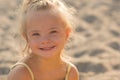 Beautiful girl with Down syndrome on the beach