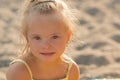 Beautiful girl with Down syndrome on the beach Royalty Free Stock Photo