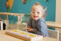 Beautiful girl with down syndrome engaged in class