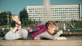 Beautiful girl draws in a notebook near the fountain