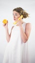 Beautiful girl in a dress with a banana in his hand,on a white background Royalty Free Stock Photo