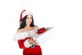 A beautiful girl dressed as Santa Claus is holding a box with a gift on a white background. Insulations. Royalty Free Stock Photo